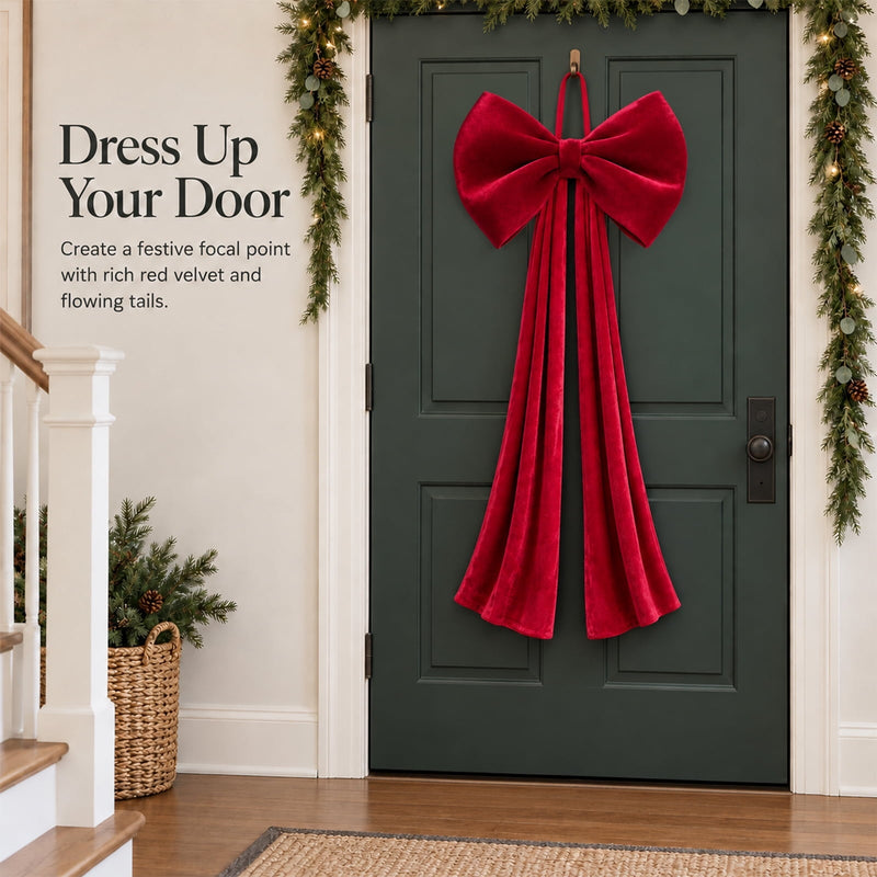 Red velvet Christmas bow decorating a green front door