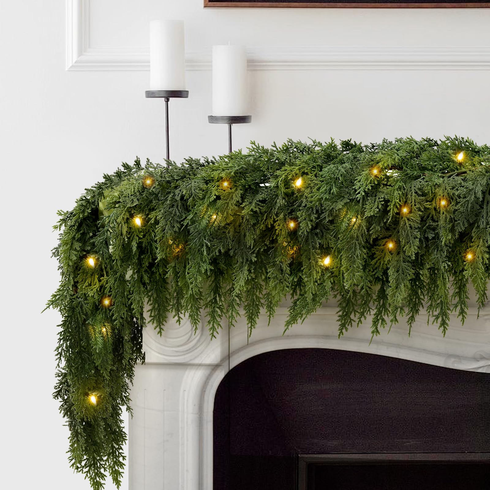 Pre-lit cedar garland displayed on a fireplace mantel