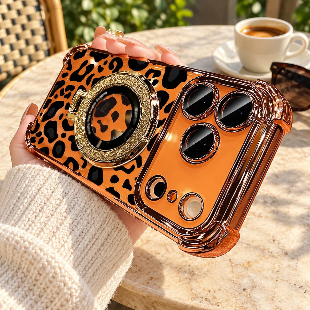 Warm gold leopard phone case held during an outdoor coffee break
