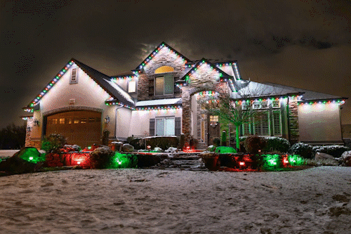 Outdoor lights changing color along a house roofline